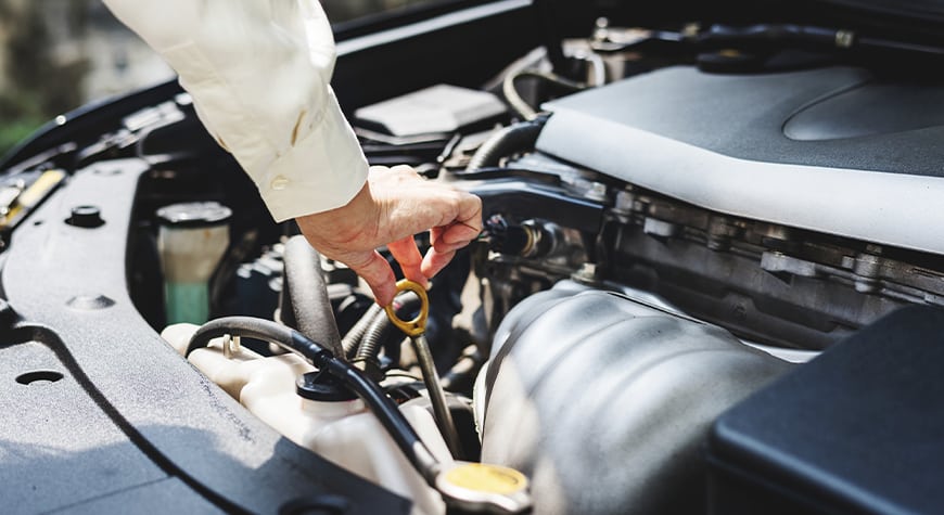 Hombre cambiando el aceite del motor a su coche